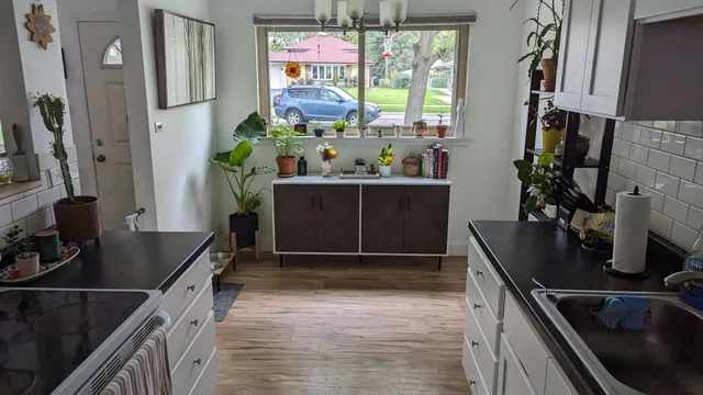 a kitchen with stainless steel appliances a sink stove and cabinets