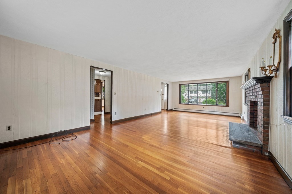 3 Winfield Road Hingham, MA 02043 - Photo 11 of 39 an empty room with wooden floor fireplace and windows
