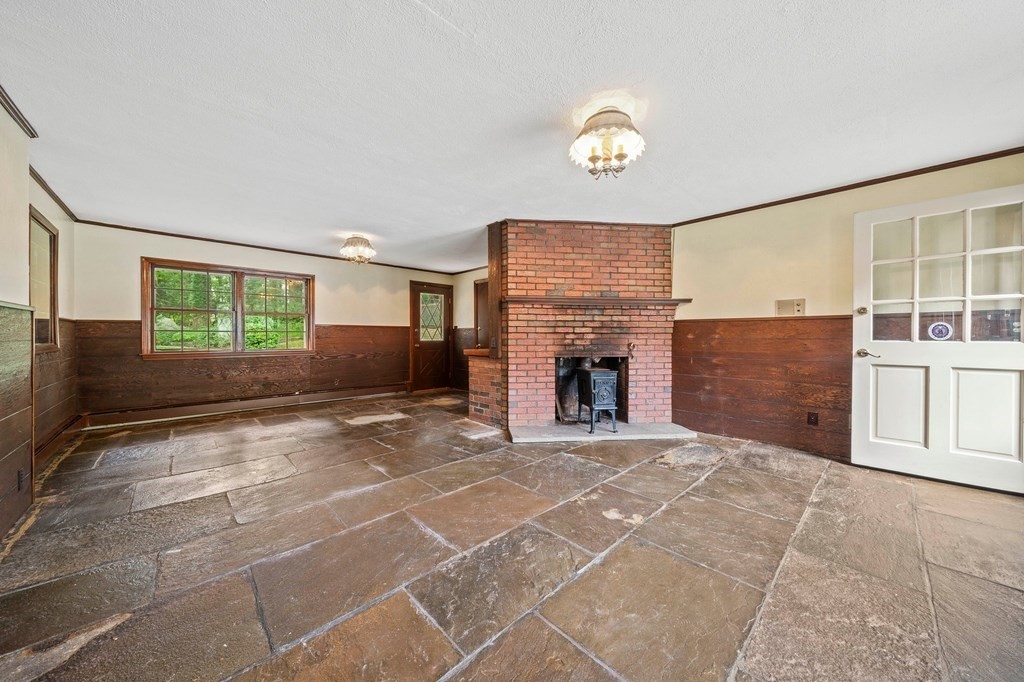 3 Winfield Road Hingham, MA 02043 - Photo 12 of 39 a view of an empty room with a fireplace and a window