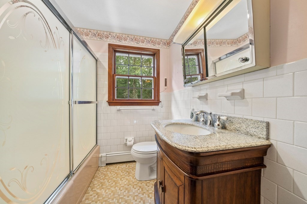 3 Winfield Road Hingham, MA 02043 - Photo 27 of 39 a bathroom with a granite countertop sink and a toilet
