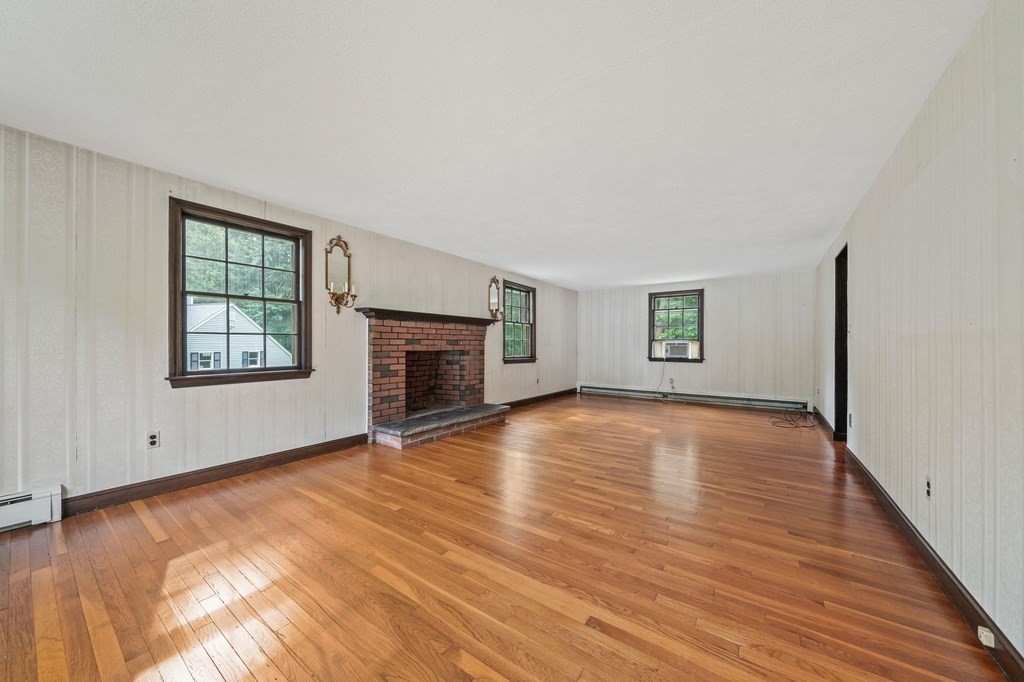 3 Winfield Road Hingham, MA 02043 - Photo 9 of 39 an empty room with windows and fireplace