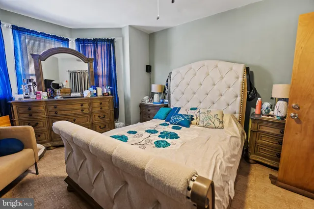 a bedroom with a bed and a dresser in it