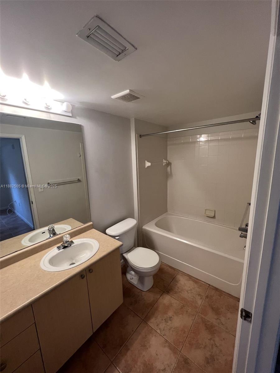 1919 Van Buren Street, Unit 408A Hollywood, FL 33020 - Photo 11 of 19 a bathroom with a sink a toilet and shower