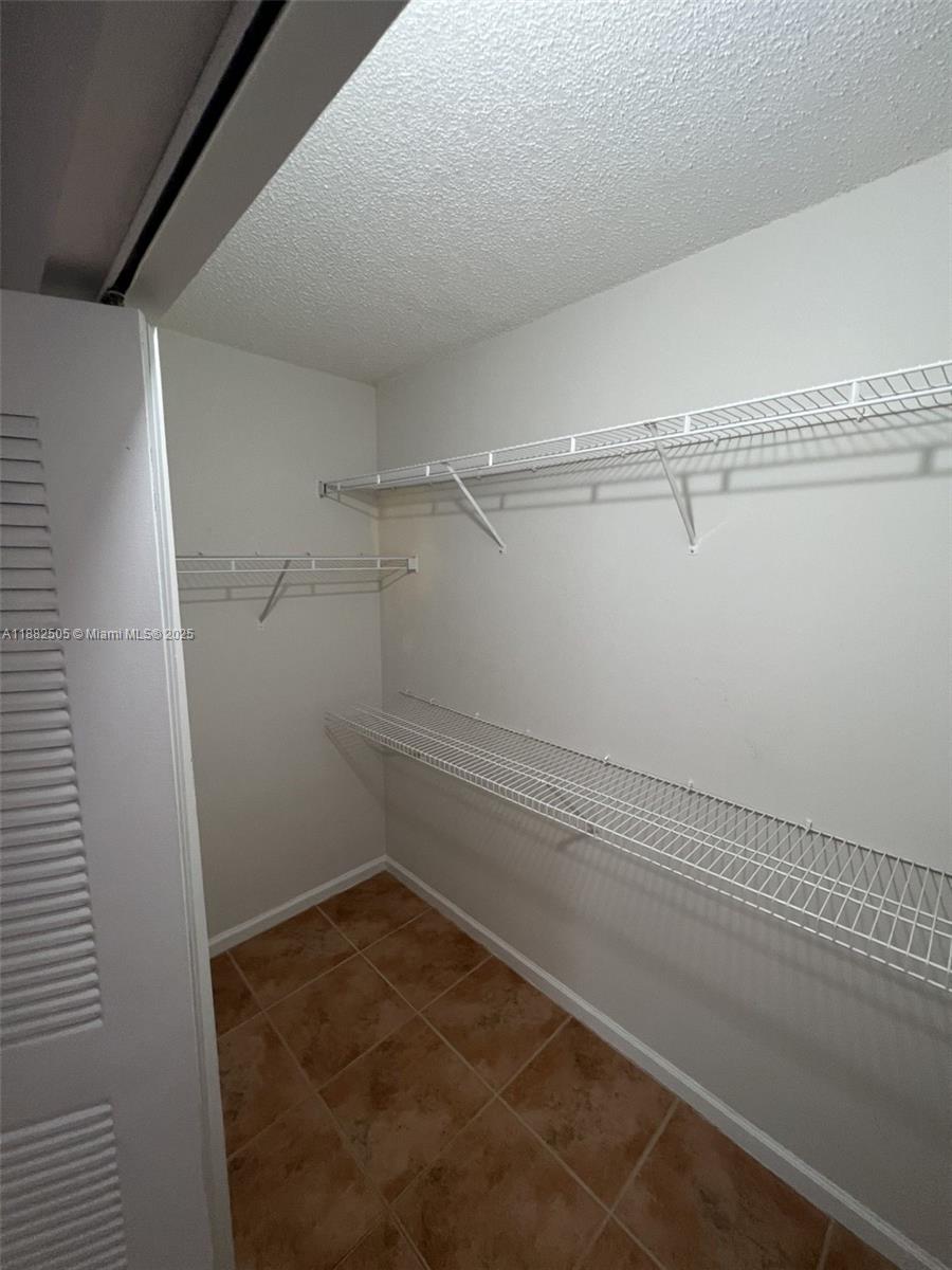 1919 Van Buren Street, Unit 408A Hollywood, FL 33020 - Photo 14 of 19 a view of a room with racks on the wall