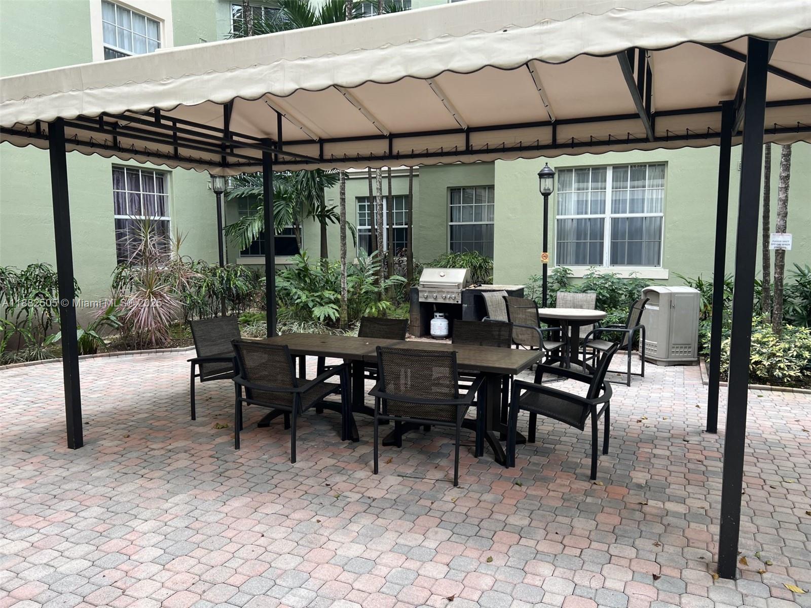 1919 Van Buren Street, Unit 408A Hollywood, FL 33020 - Photo 15 of 19 a view of a patio with table and chairs and potted plants