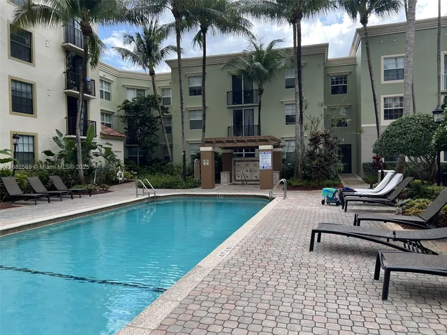 a swimming pool with outdoor seating