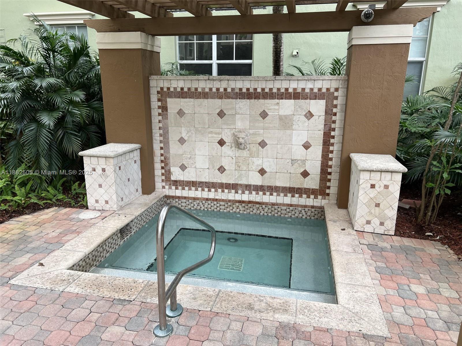 1919 Van Buren Street, Unit 408A Hollywood, FL 33020 - Photo 18 of 19 a front view of a house with a garden