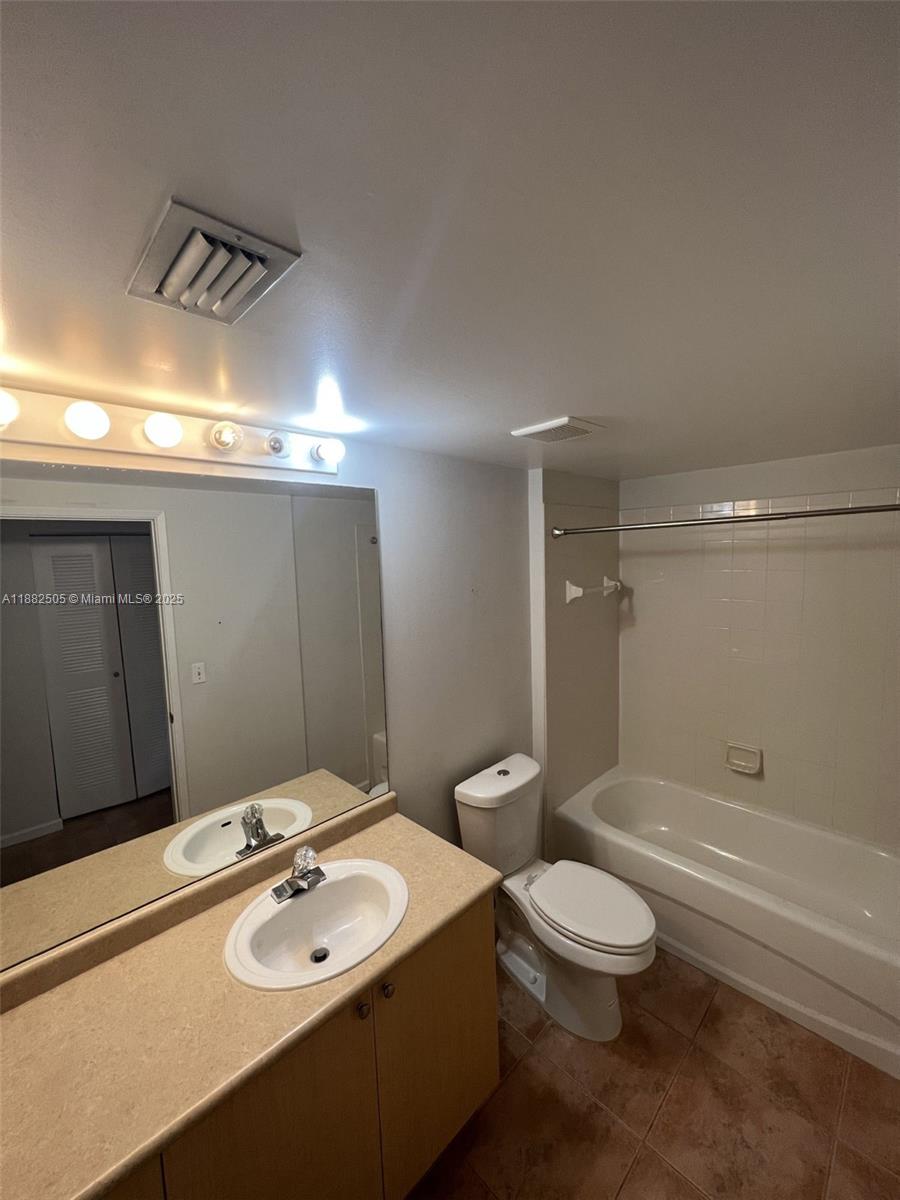 1919 Van Buren Street, Unit 408A Hollywood, FL 33020 - Photo 7 of 19 a bathroom with a sink a toilet and shower