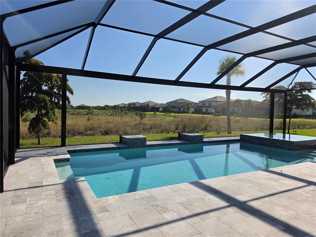 18334 Ridgeline Drive Estero, FL 33928 - Photo 18 of 30 a view of a swimming pool with a patio