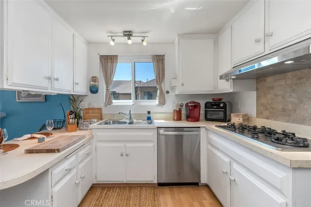 a kitchen with a sink stove and cabinets