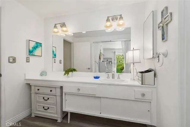 a bathroom with a double vanity sink mirror and next to a window