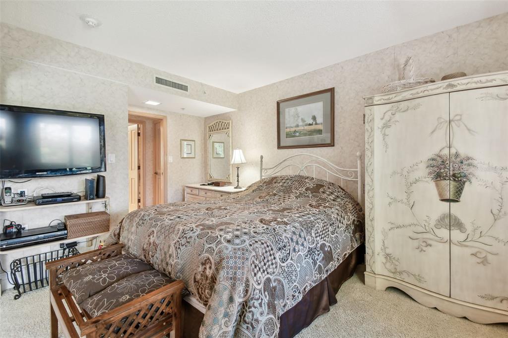 36750 US Highway 19 North, Unit 22207 Palm Harbor, FL 34683 - Photo 16 of 50 a bedroom with a bed and a flat screen tv