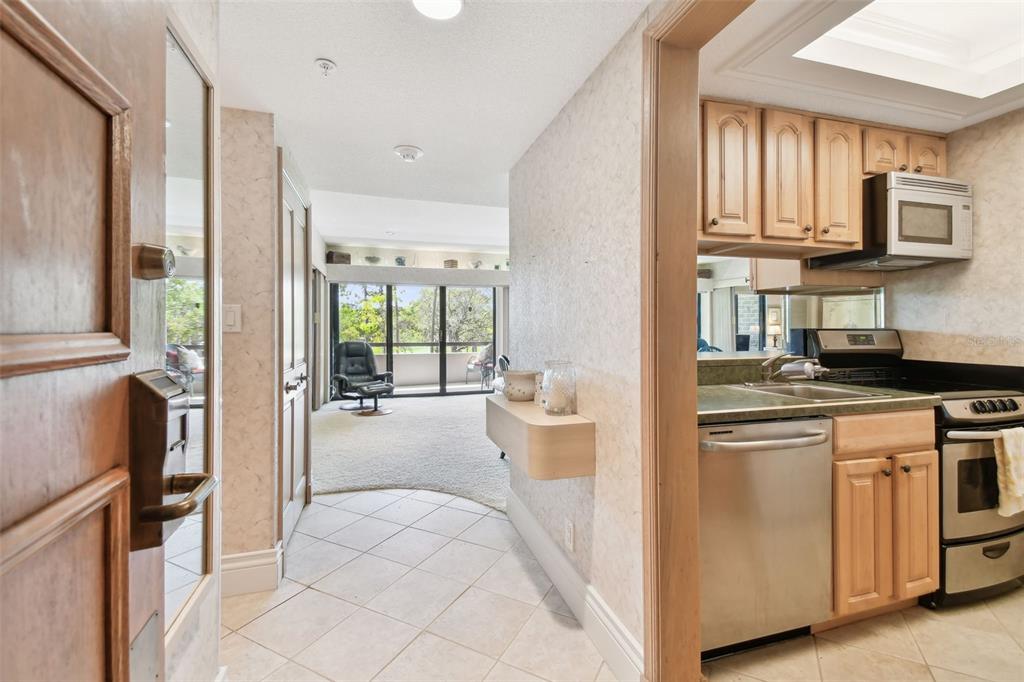 36750 US Highway 19 North, Unit 22207 Palm Harbor, FL 34683 - Photo 5 of 50 a kitchen with a stove a refrigerator and a view of living room