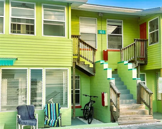 a view of a house with a chairs and a porch