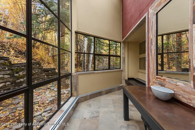 a en suite bathroom with a granite countertop sink and a mirror