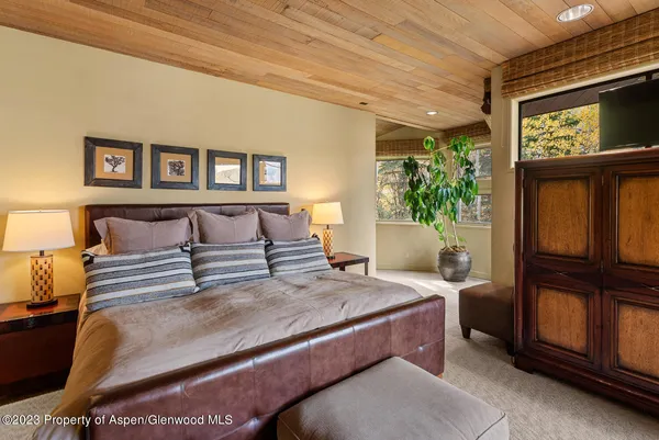 a bedroom with a bed and a mirror