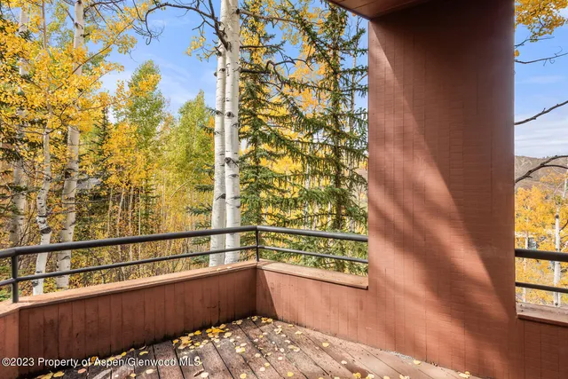 a bedroom with furniture and a painting on the wall