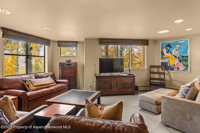 a bathroom with a granite countertop sink a mirror and shower