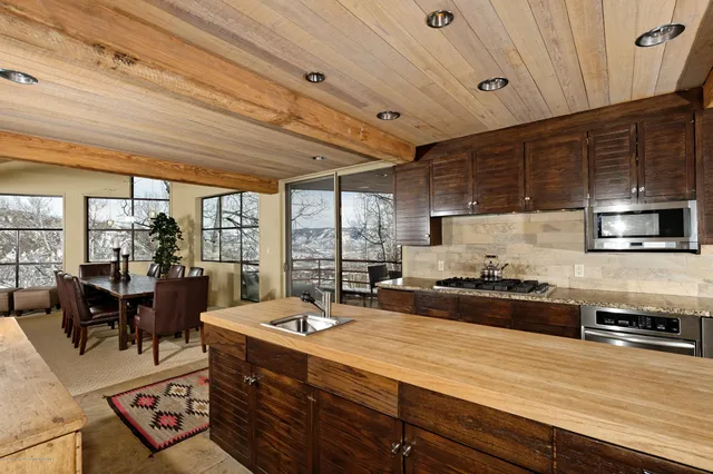 a kitchen with granite countertop sink and cabinets