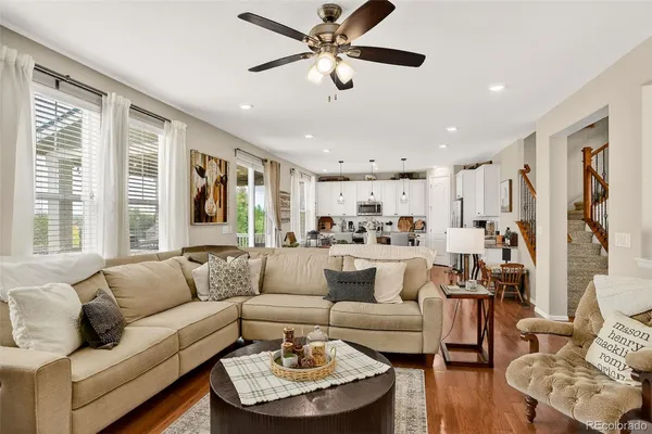 a living room with furniture kitchen and a chandelier