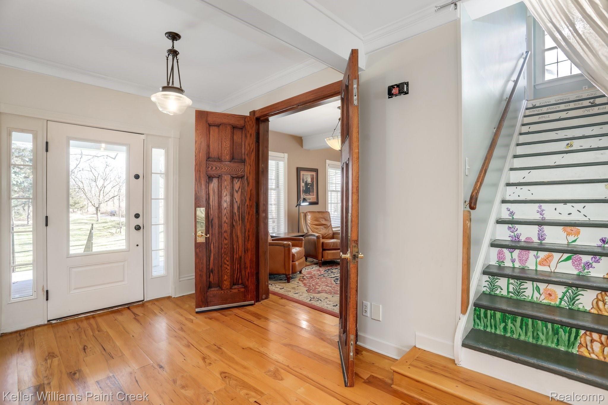 115 Michael Road Lapeer, MI 48446 - Photo 19 of 64 Double Wood Doors separate the Home Office from the Main Entryway while the playful Custom Painted Staircase leads you to the Home's 2nd Level