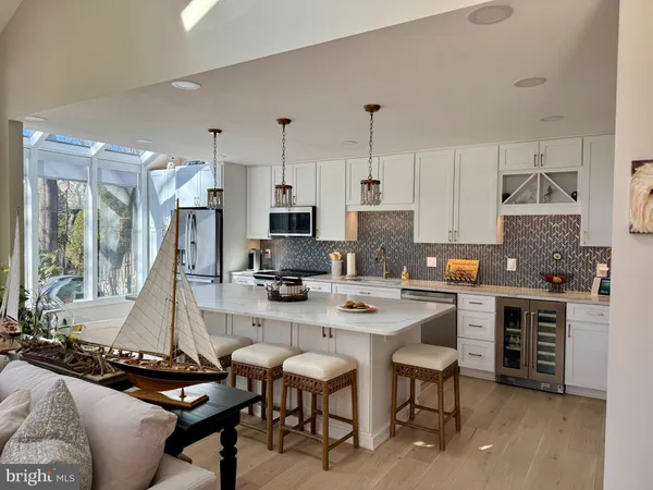 a kitchen with stainless steel appliances a stove a sink a microwave a refrigerator and cabinets