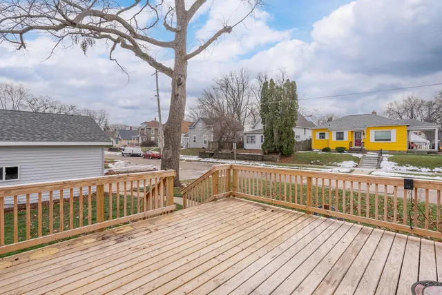 a view of balcony with wooden floor and fence