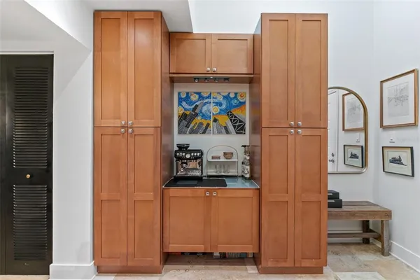 a kitchen with a sink and a wooden floor