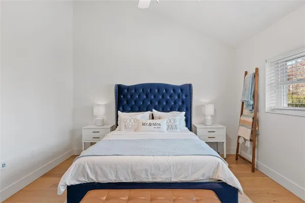 a bedroom with a bed and a night stand