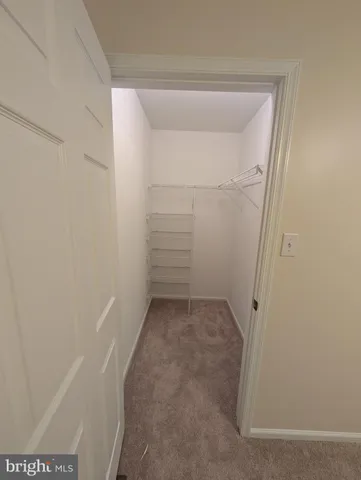 en empty room with windows and fan