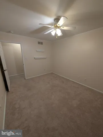 an empty room with staircase and white walls