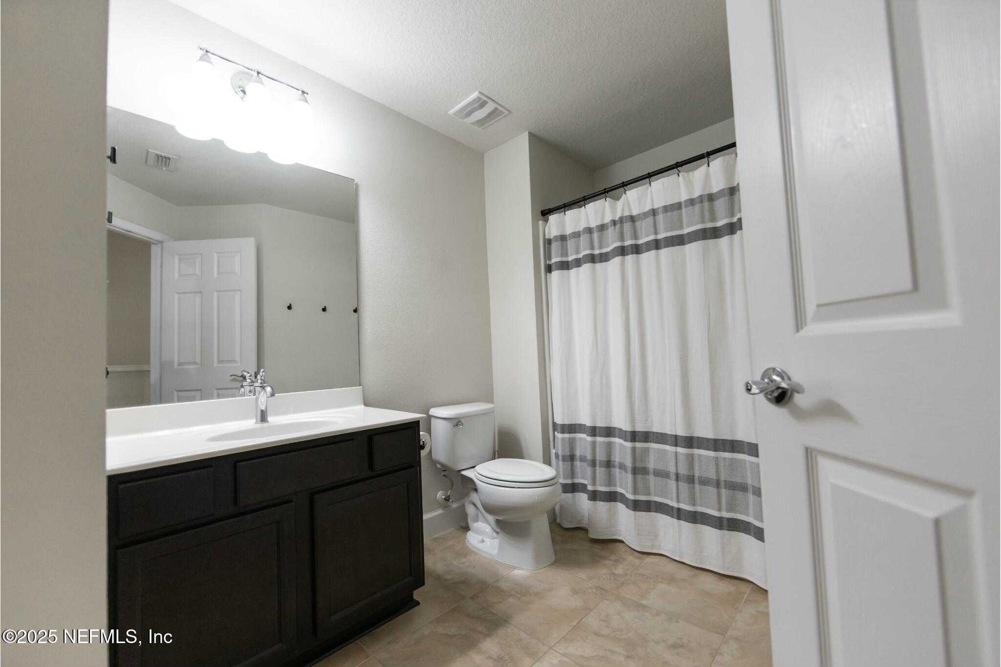 6862 Roundleaf Drive Jacksonville, FL 32258 - Photo 24 of 32 a bathroom with a sink toilet and shower