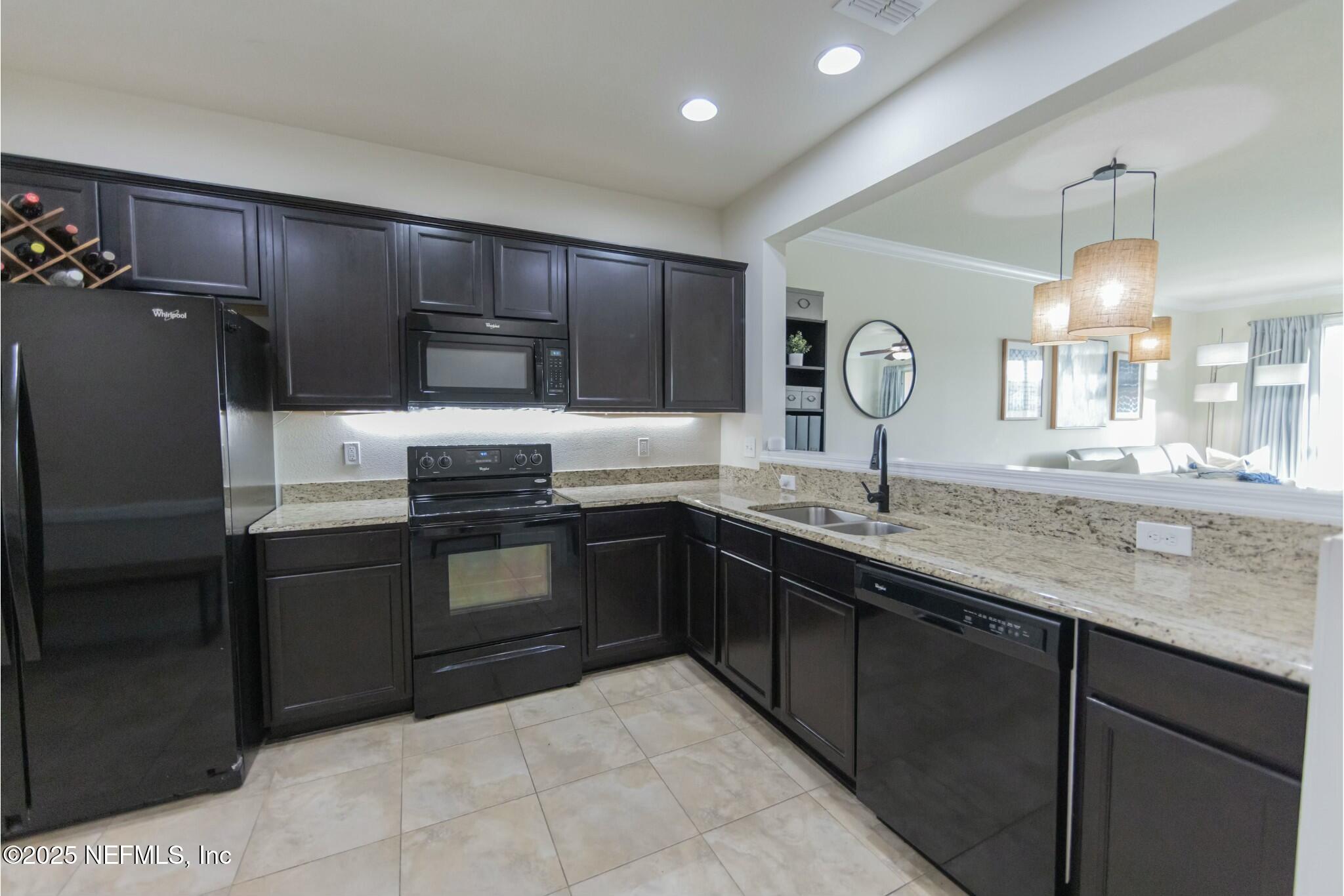 6862 Roundleaf Drive Jacksonville, FL 32258 - Photo 6 of 32 a kitchen with granite countertop a refrigerator and a sink