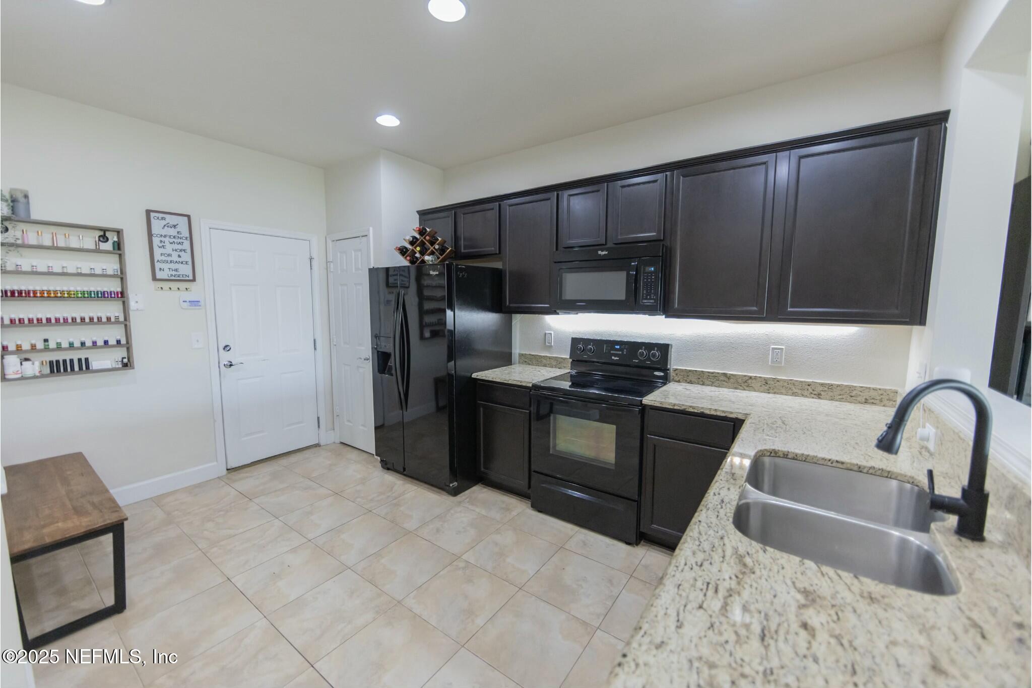 6862 Roundleaf Drive Jacksonville, FL 32258 - Photo 7 of 32 a kitchen with stainless steel appliances granite countertop a refrigerator and a sink