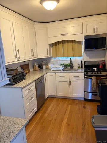 a kitchen with a sink a stove and cabinets