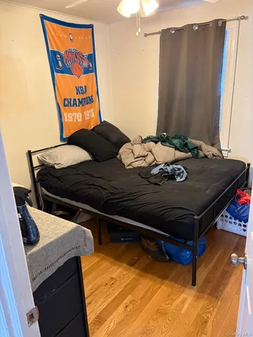 a bed sitting in a room next to a window