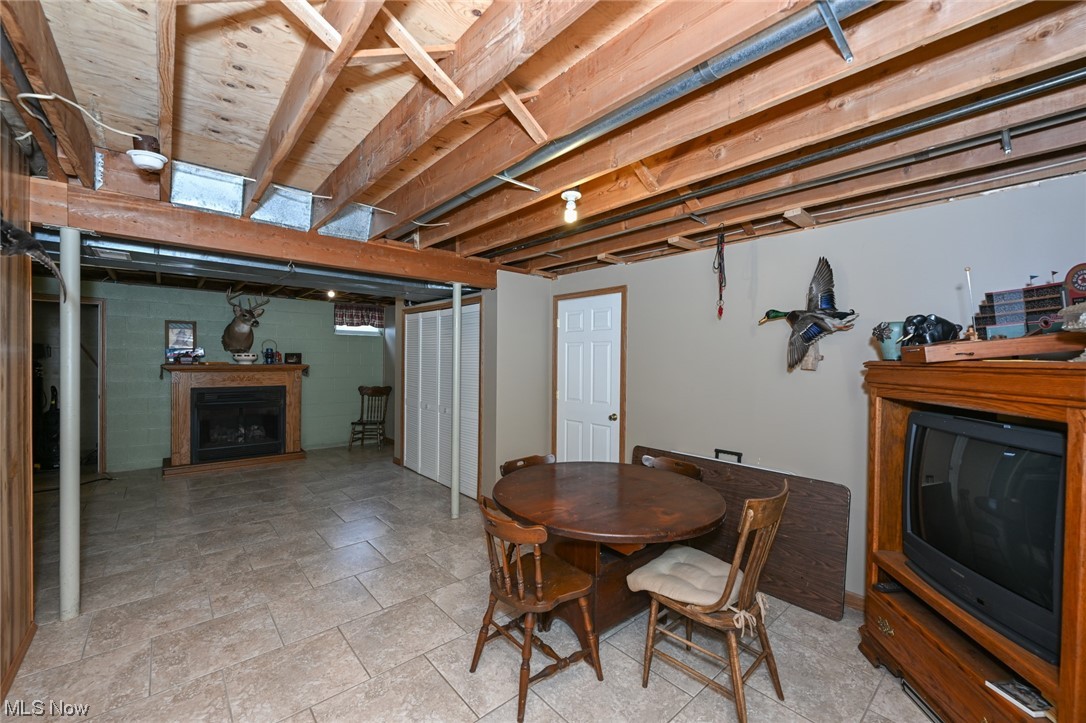 3749 Webb Road Ravenna, OH 44266 - Photo 28 of 31 Basement tiled floor, with the fireplace in the distance.