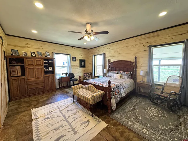 a bedroom with a large bed and a chandelier