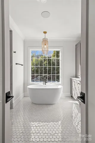 a large spacious bathroom with a double vanity sink a large mirror and a bathtub