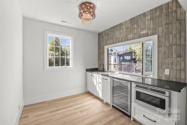 a view of a livingroom with wooden floor and windows
