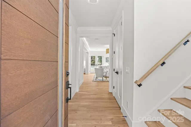 a view of a hallway with a livingroom and a bathroom with sink