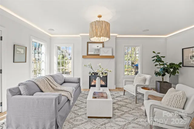 a living room with furniture a window and a chandelier