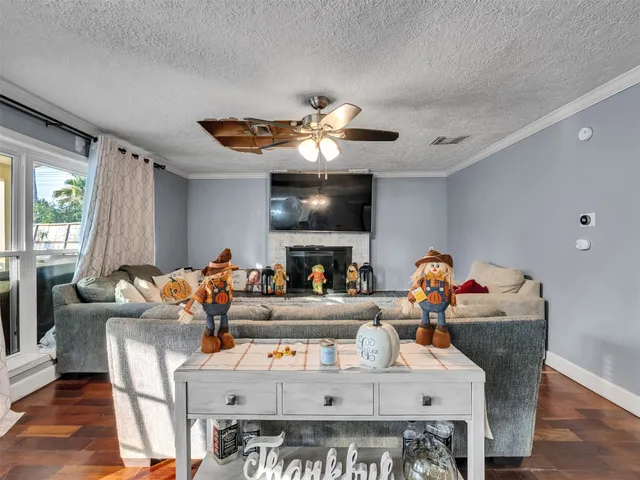 a living room with furniture a chandelier and a fireplace