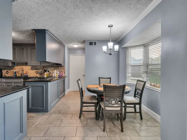a kitchen with a dining table and chairs