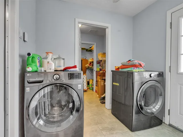 a utility room with sink dryer and washer