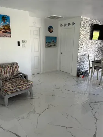 a living room with furniture and a dining table