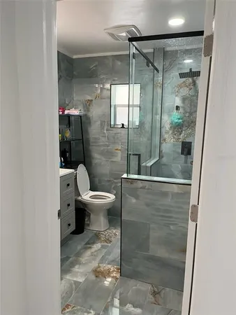 a bathroom with a shower and toilet