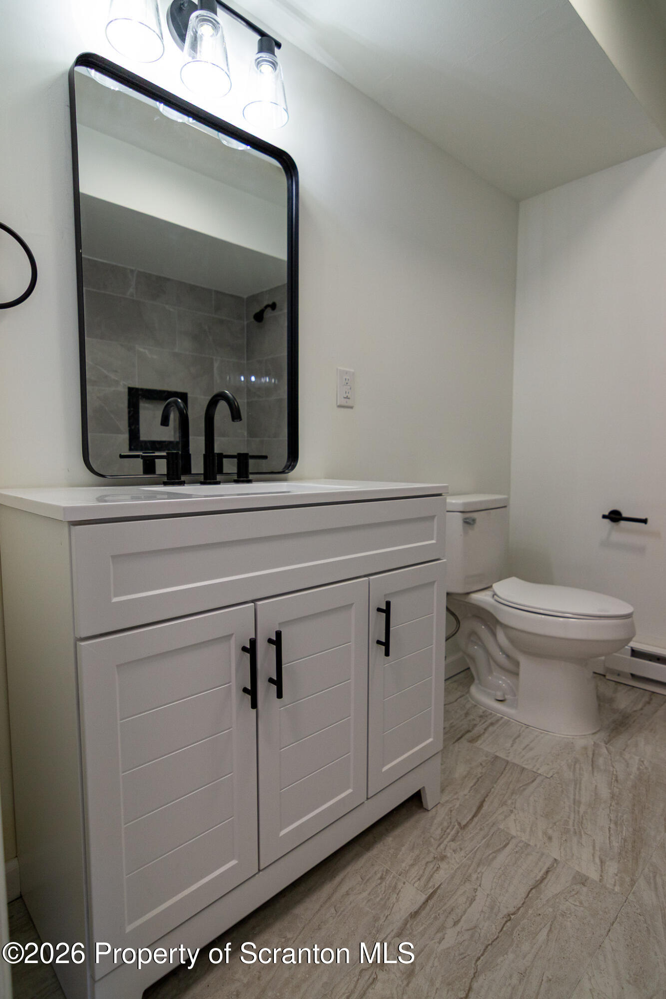 804 Grace Lane Moosic, PA 18507 - Photo 18 of 34 a bathroom with a toilet a sink and mirror