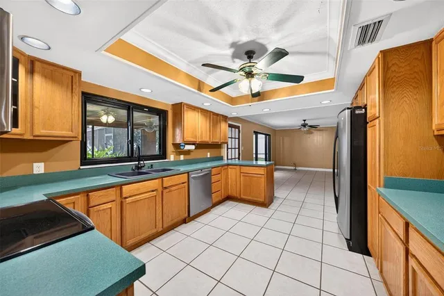 a kitchen with stainless steel appliances granite countertop a sink a stove counter space and cabinets
