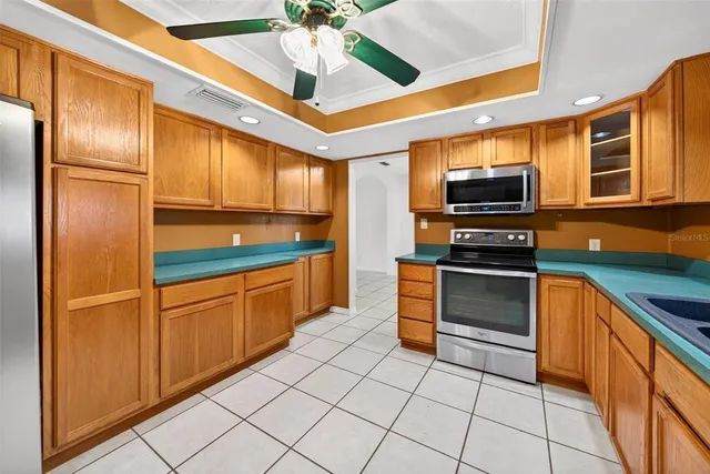 a bathroom with a granite countertop toilet a sink and a mirror